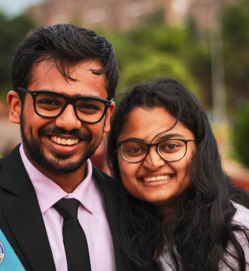 Two graduates smiling on their convocation day