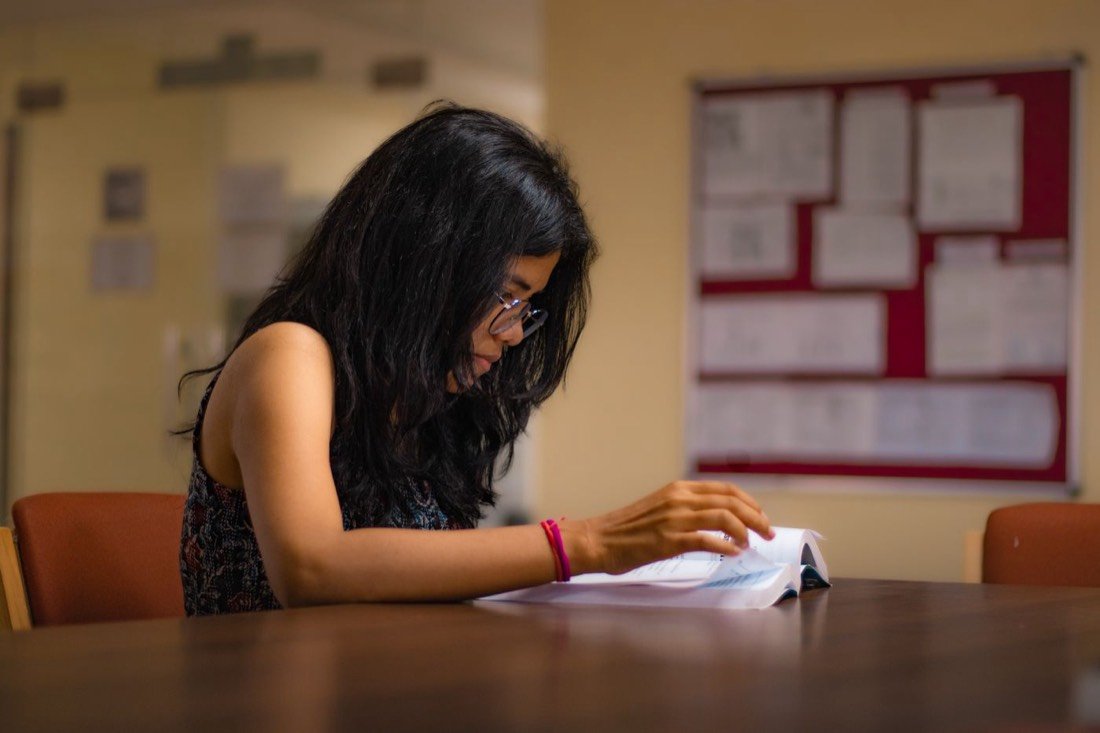 A student reading through college admission papers